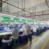 Organized toy assembly line with workers performing production and quality checks
